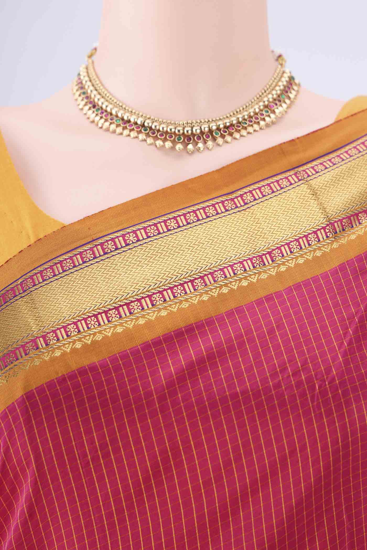 Border image of Rani Pink Narayanpet Silk Saree with Checked design on the body and Zari Border. 