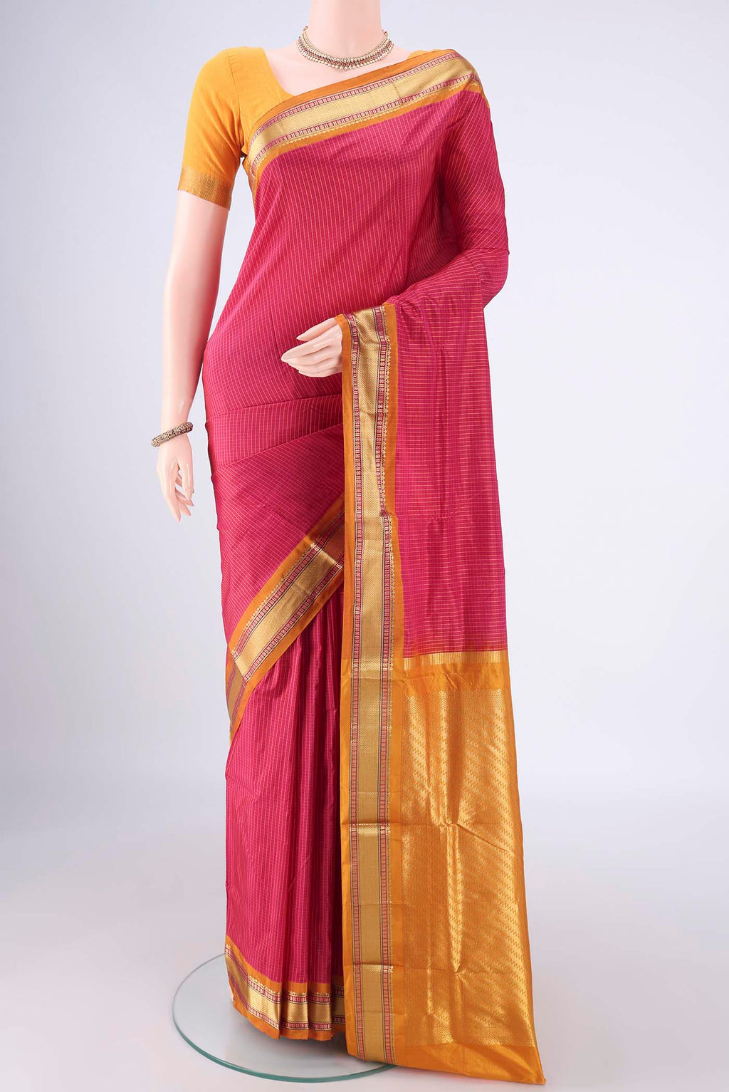 Rani Pink Narayanpet Silk Saree with Checked design on the body and Zari Border.  displayed on a mannequin