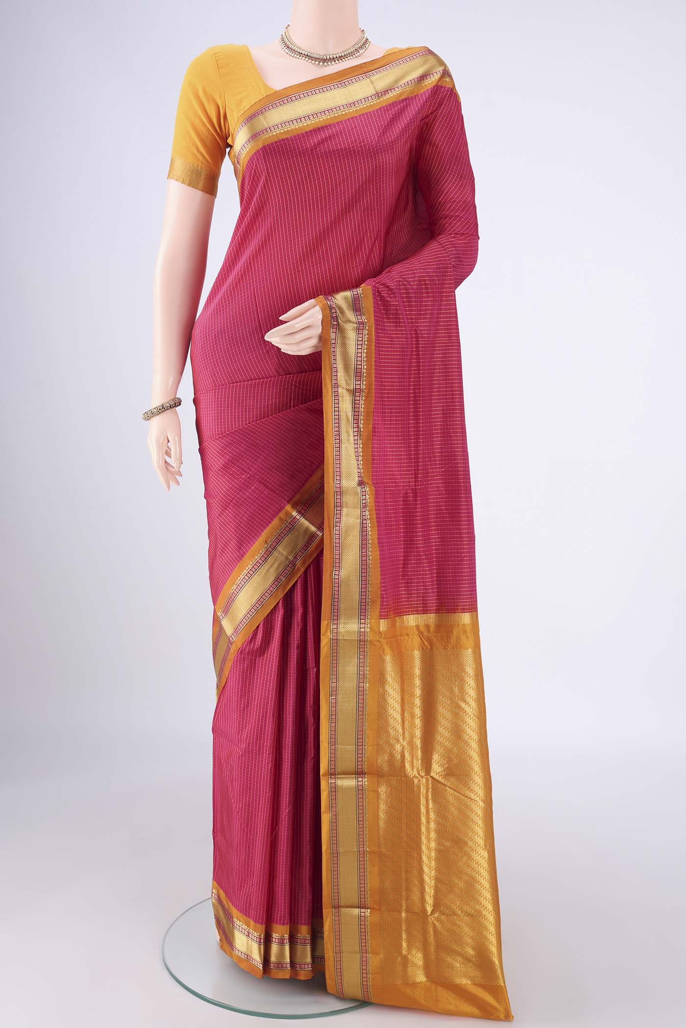 Rani Pink Narayanpet Silk Saree with Checked design on the body and Zari Border.  displayed on a mannequin