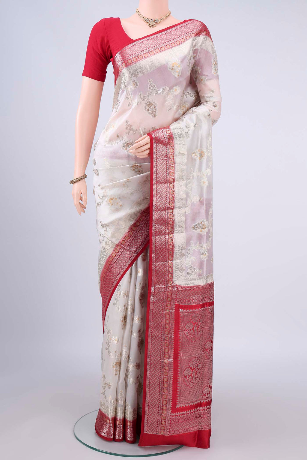 Pure Silk White Banarasi Raw Saree with Zari Butta on the body and Zari Border.  displayed on a mannequin