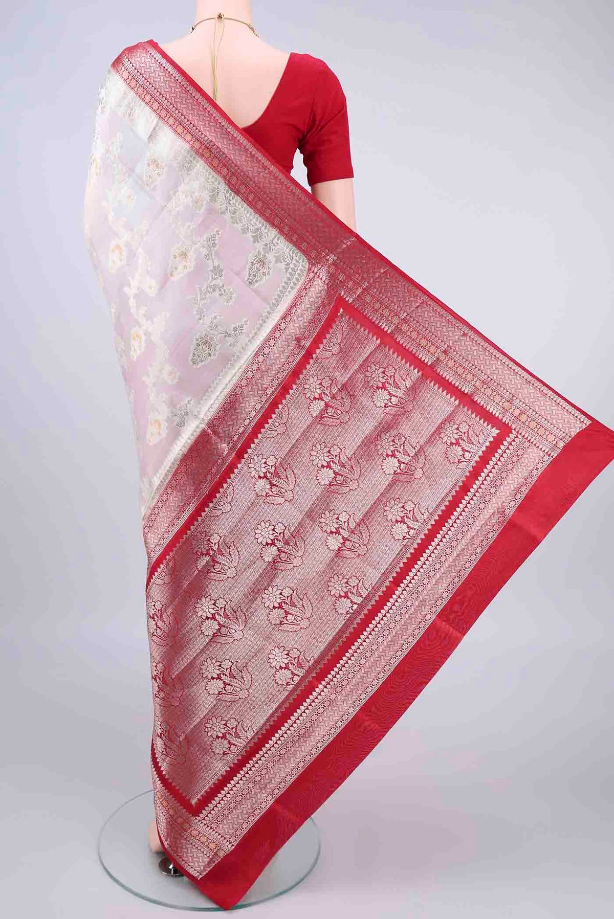 Flat view of Pure Silk White Banarasi Raw Saree with Zari Butta on the body and Zari Border. 