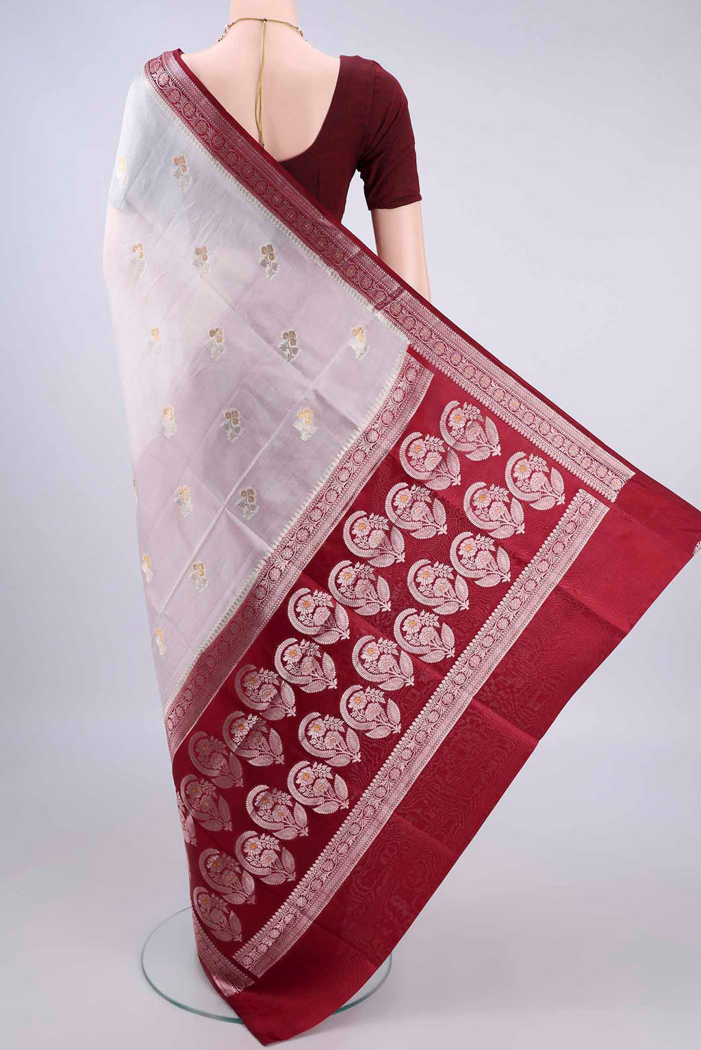 Flat view of Pure Silk White Banarasi Raw Saree with Zari Butta on the body and Zari Border. 