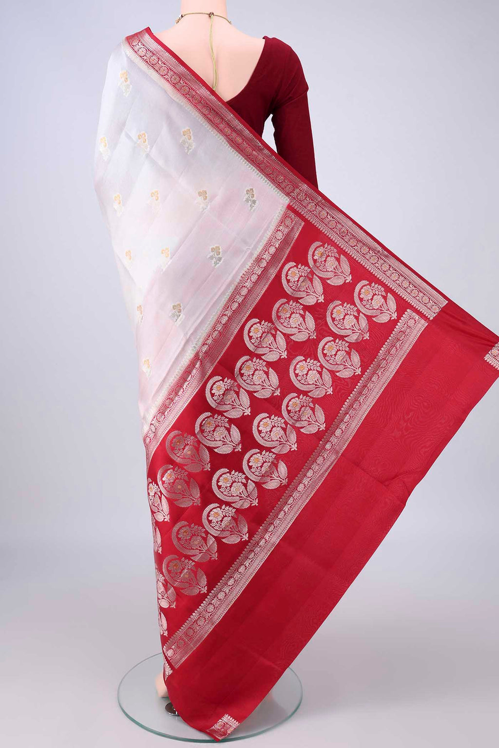 Flat view of Pure Silk White Banarasi Raw Saree with Zari Butta on the body and Zari Border. 