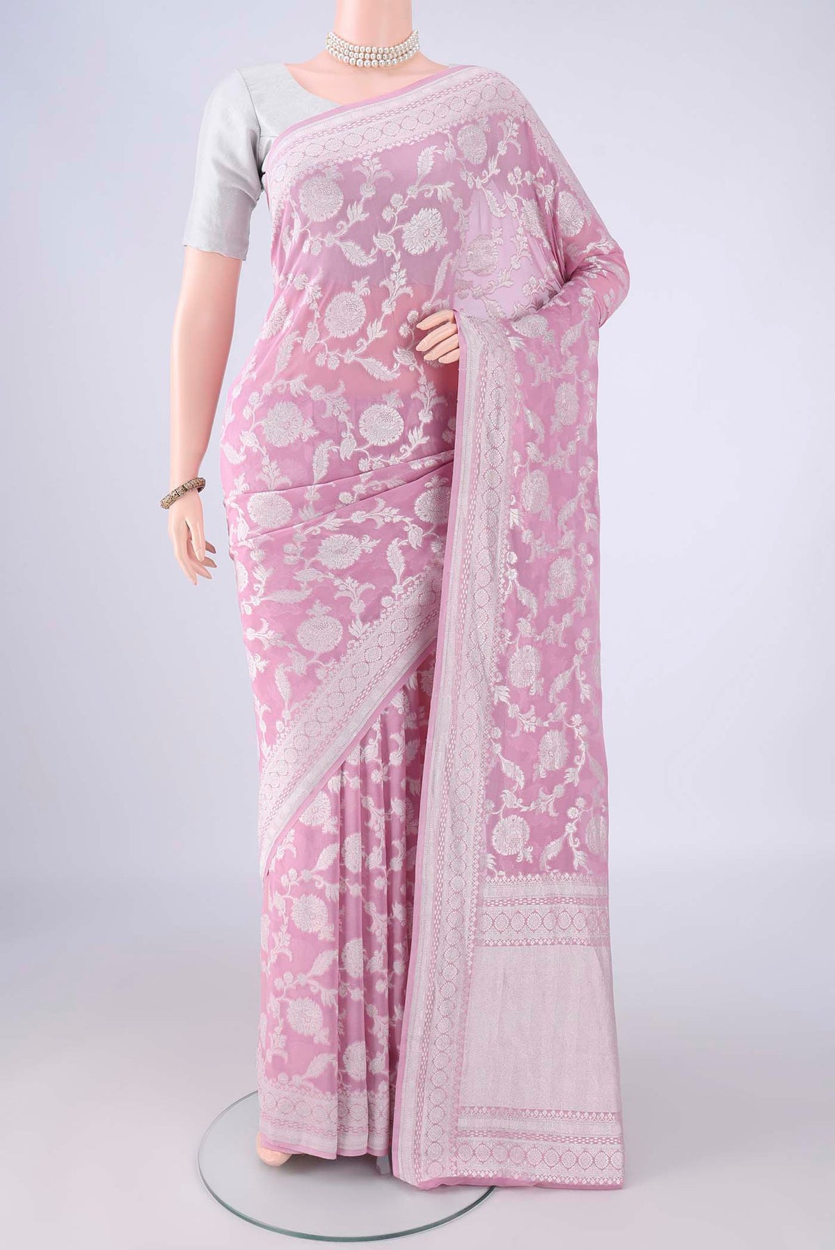 Rose pink Banarasi Georgette Saree with Zari Brocade on the body and Zari Border.  displayed on a mannequin