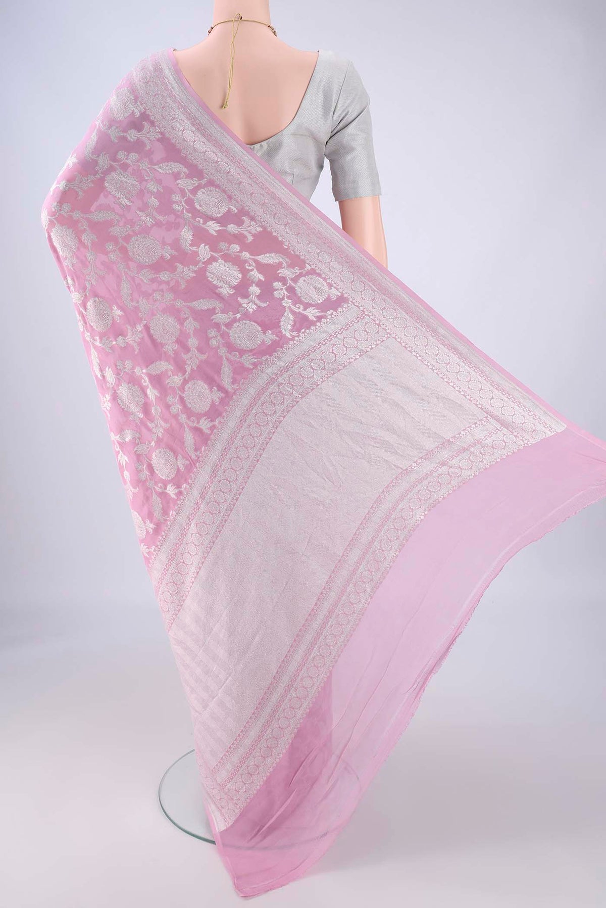 Flat view of Rose pink Banarasi Georgette Saree with Zari Brocade on the body and Zari Border. 