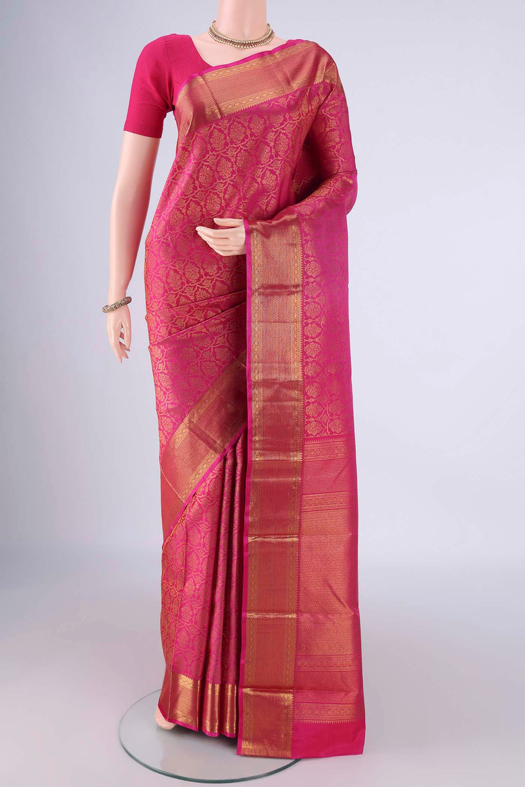 Rani Pink Kanchipuram Silk Saree with Zari Brocade on the body and Zari Border.  displayed on a mannequin