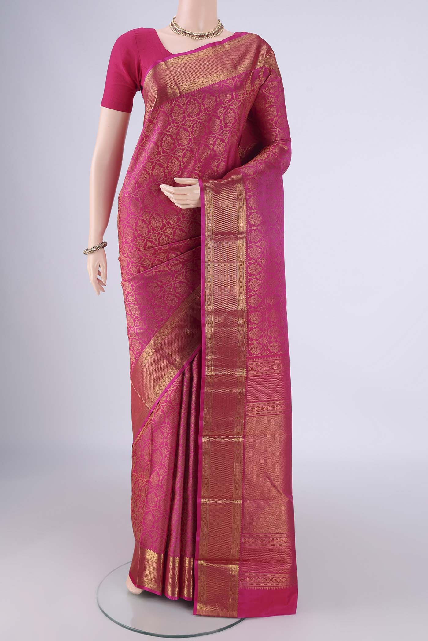 Rani Pink Kanchipuram Silk Saree with Zari Brocade on the body and Zari Border.  displayed on a mannequin