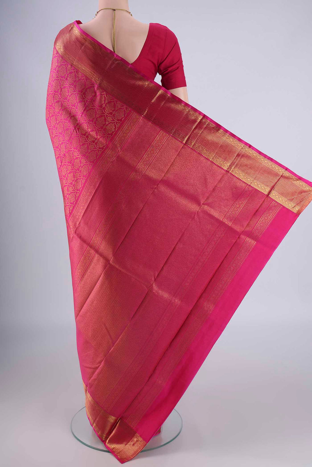 Flat view of Rani Pink Kanchipuram Silk Saree with Zari Brocade on the body and Zari Border. 