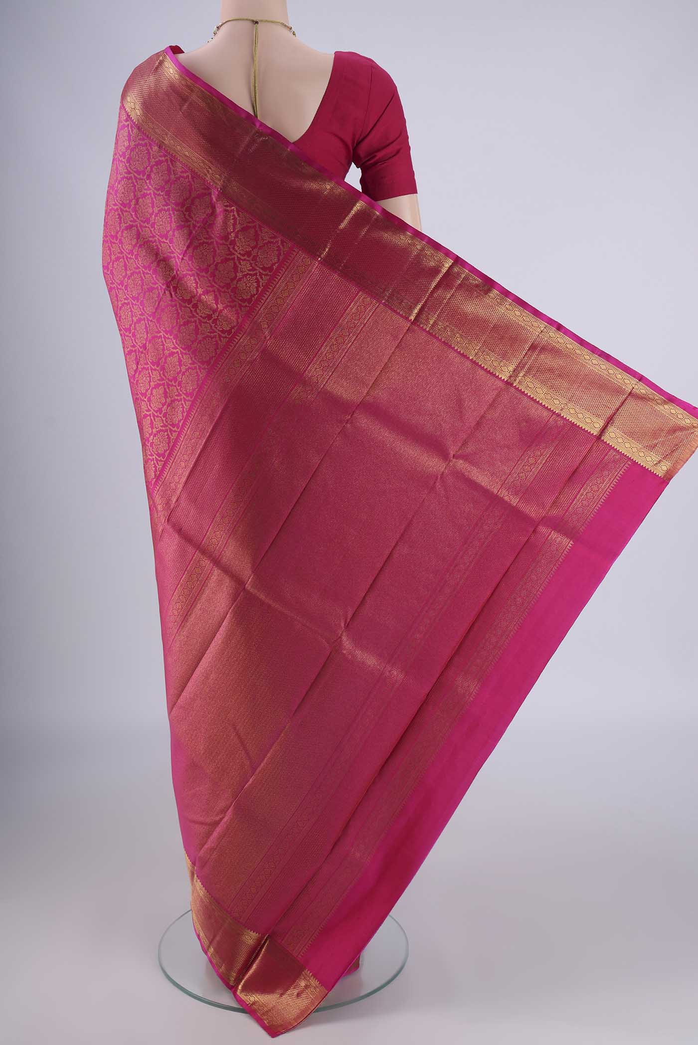 Flat view of Rani Pink Kanchipuram Silk Saree with Zari Brocade on the body and Zari Border. 