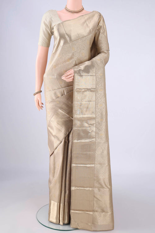 Beige Kanjivaram Silk Saree with Zari Brocade on the body and Zari Border.  displayed on a mannequin