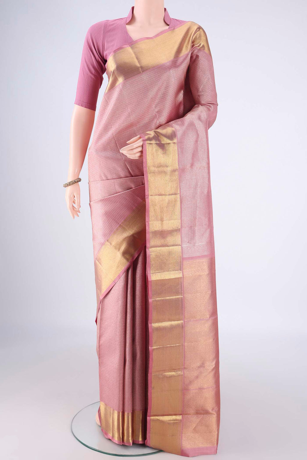 Rose Gold Kanchipuram Silk Saree with Zari Brocade on the body and Zari Border.  displayed on a mannequin