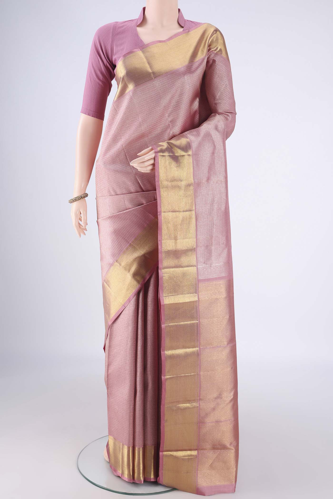 Rose Gold Kanchipuram Silk Saree with Zari Brocade on the body and Zari Border.  displayed on a mannequin