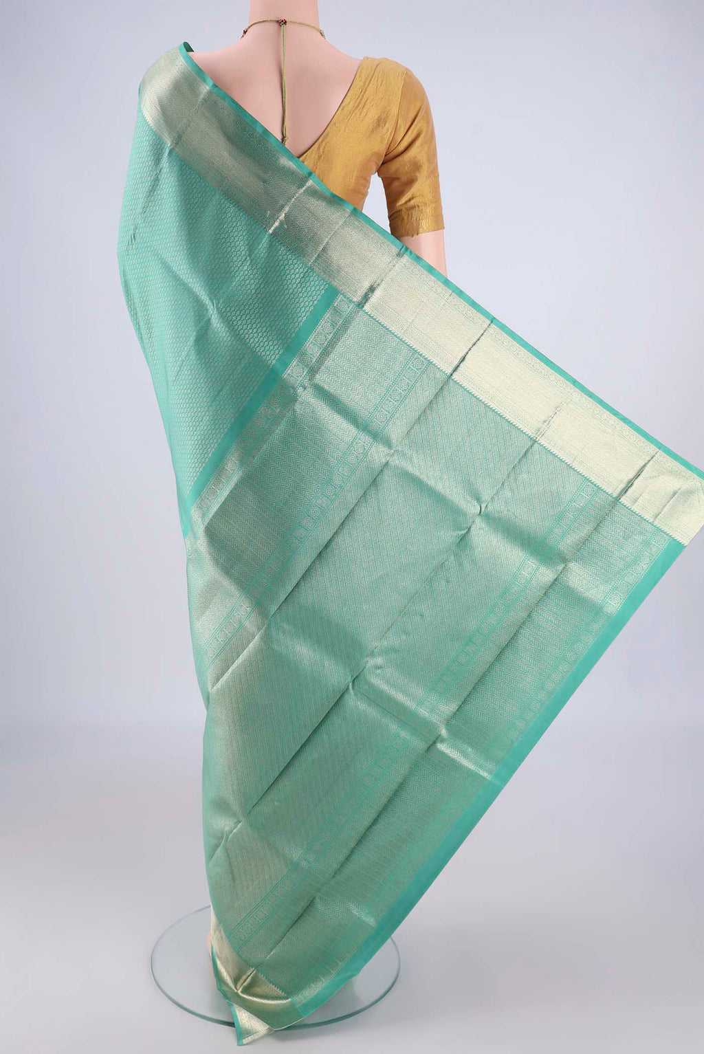 Flat view of Light Green Kanchipuram Silk Saree with Zari Brocade on the body and Zari Border. 
