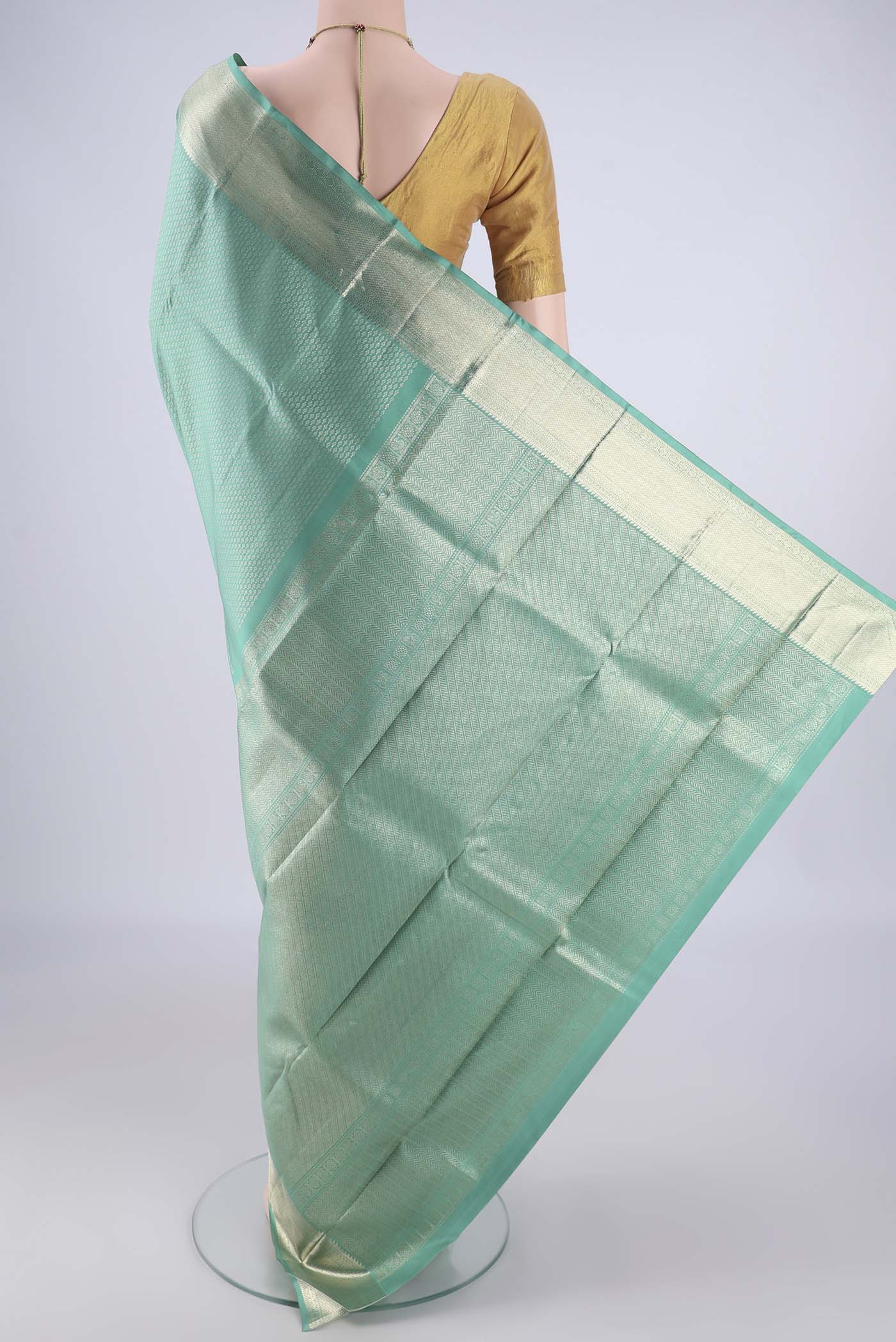 Flat view of Light Green Kanchipuram Silk Saree with Zari Brocade on the body and Zari Border. 