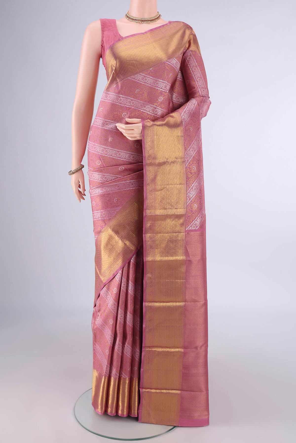Pure Silk Pure Zari Mauve Kanjivaram Saree with Zari Brocade on the body and Zari Border.  displayed on a mannequin