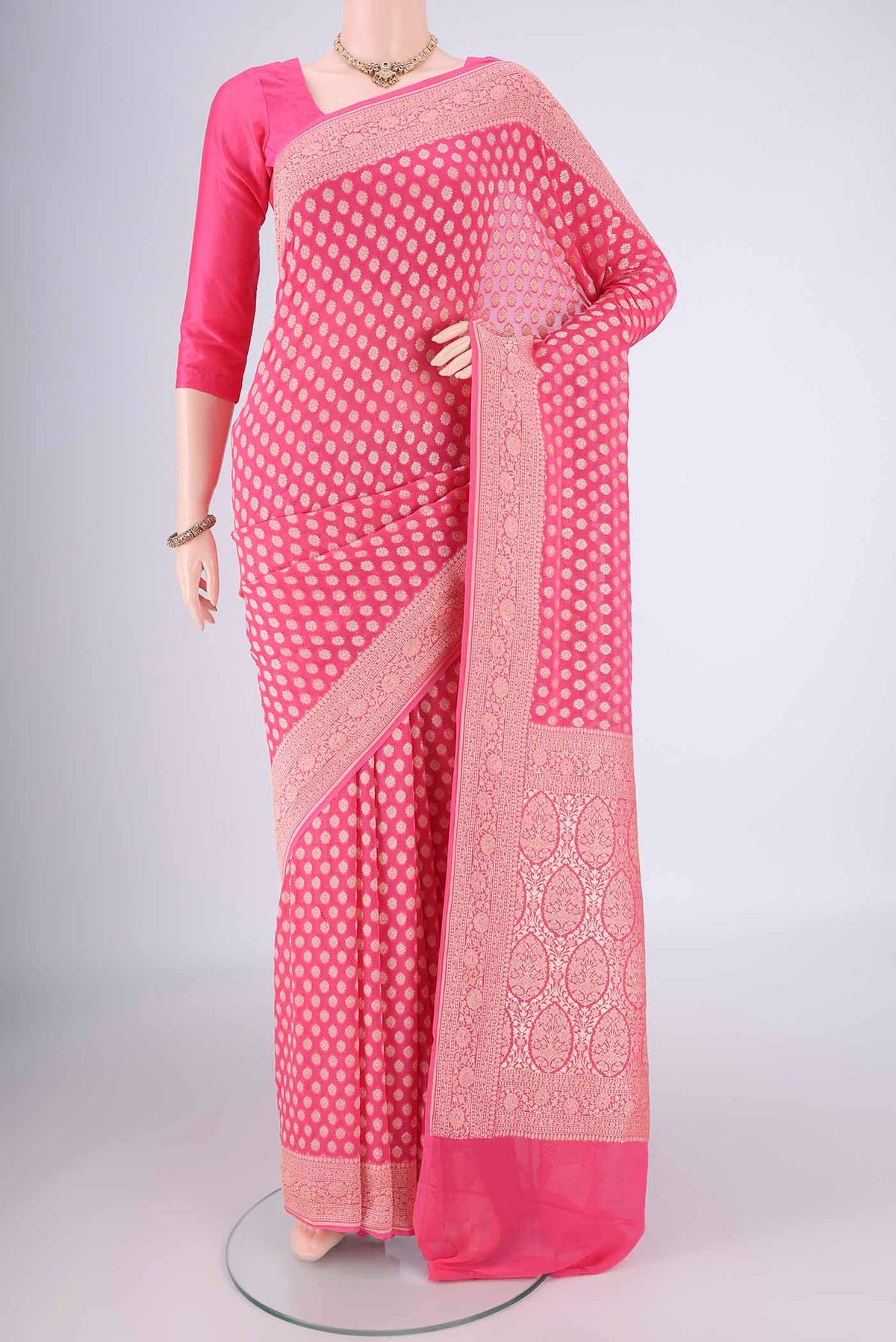 Pink Banarasi Georgette Saree with Zari Butta on the body and Zari Border.  displayed on a mannequin