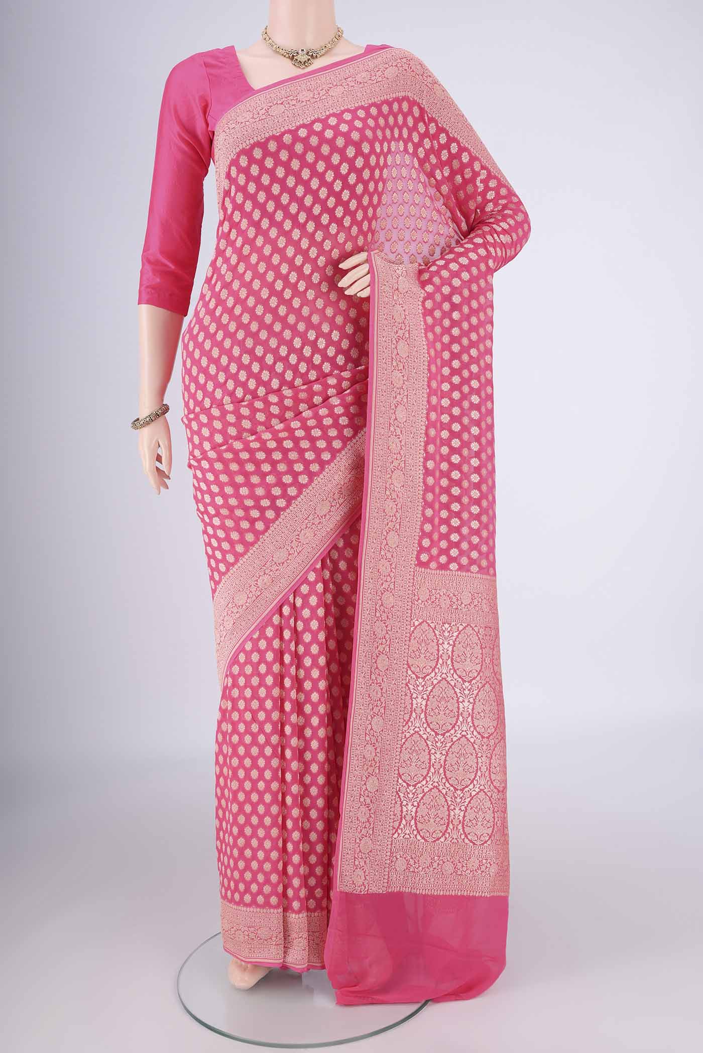 Pink Banarasi Georgette Saree with Zari Butta on the body and Zari Border.  displayed on a mannequin