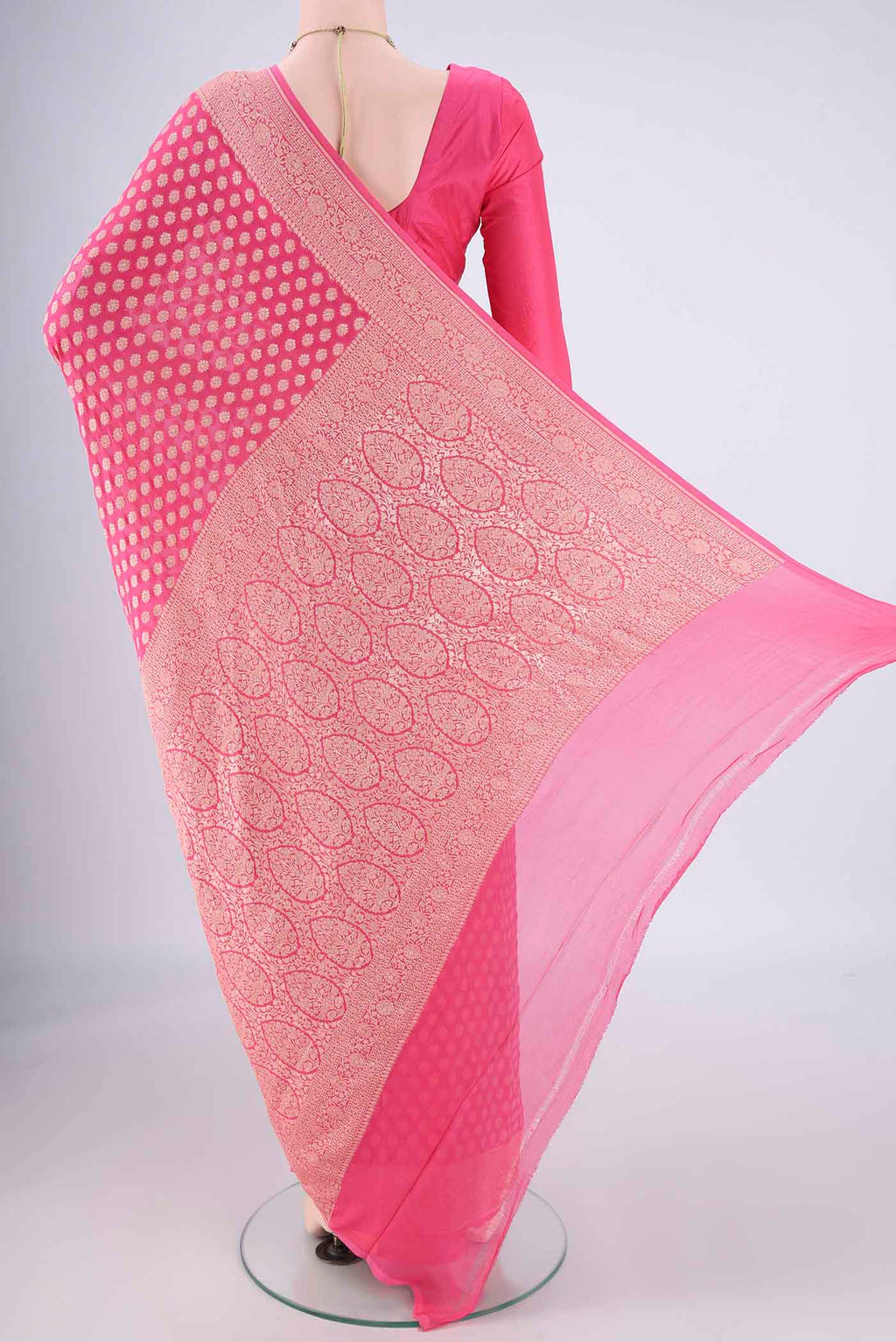 Flat view of Pink Banarasi Georgette Saree with Zari Butta on the body and Zari Border. 