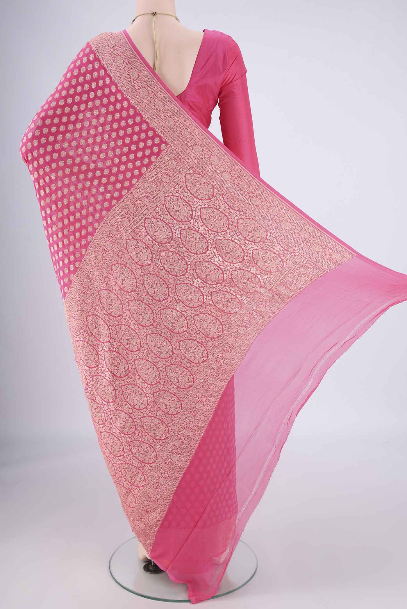 Flat view of Pink Banarasi Georgette Saree with Zari Butta on the body and Zari Border. 