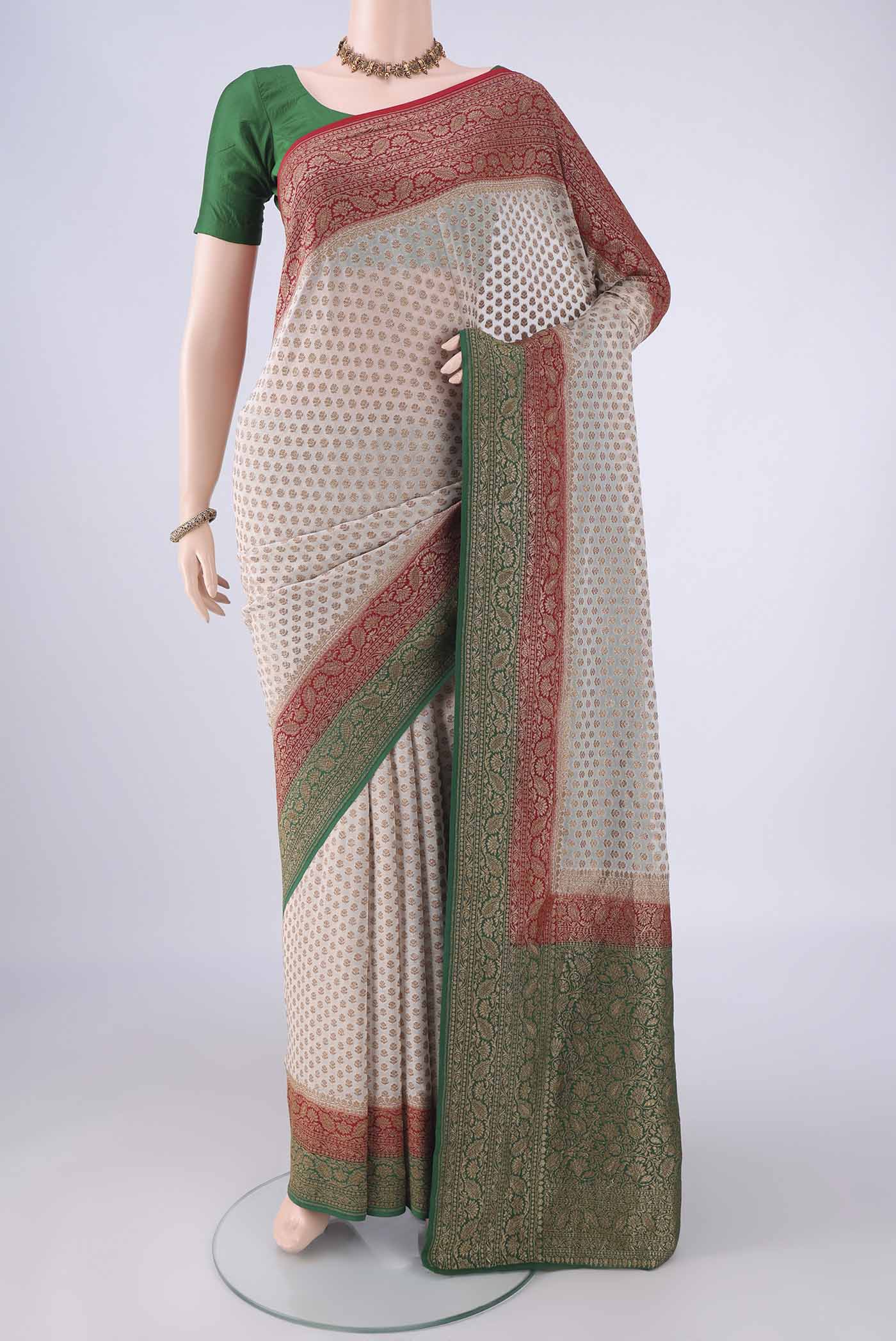 Beige Banarasi Georgette Saree with Zari Butta on the body and Zari Border.  displayed on a mannequin