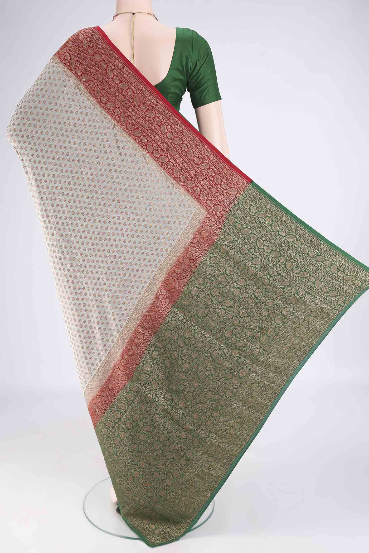 Flat view of Beige Banarasi Georgette Saree with Zari Butta on the body and Zari Border. 