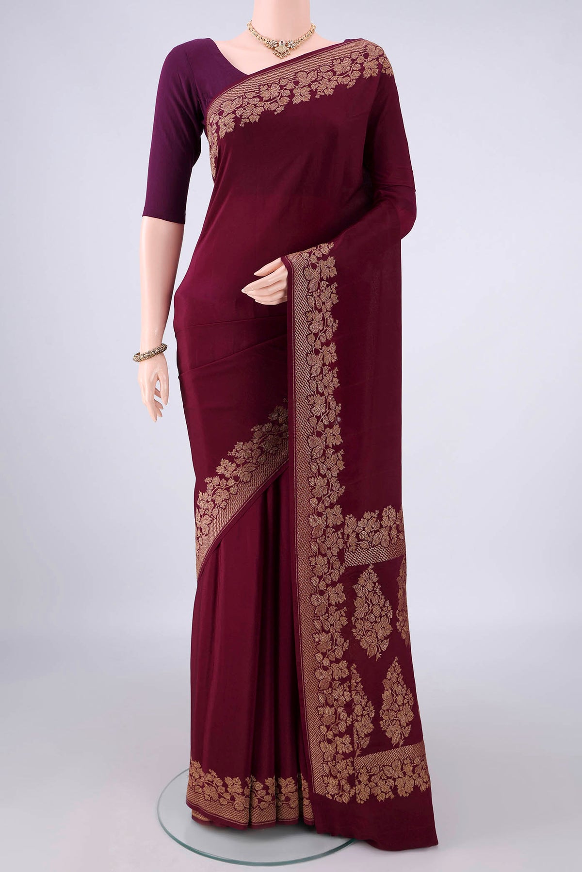Maroon Banarasi Georgette Saree with Plain Body and Zari Border.  displayed on a mannequin