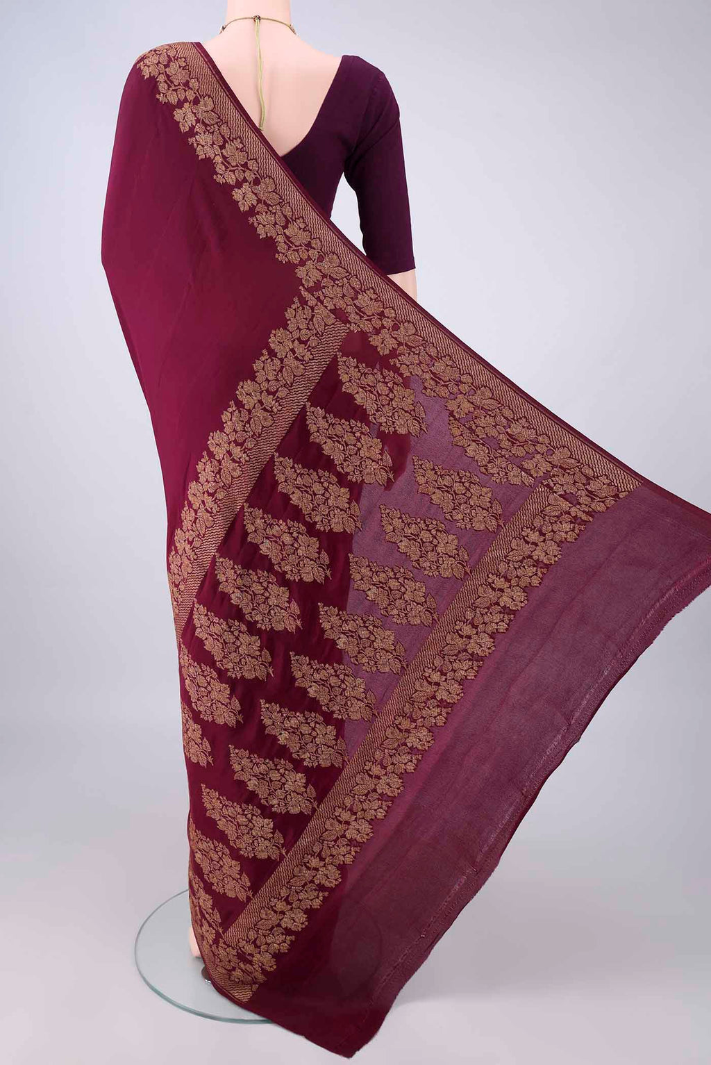 Flat view of Maroon Banarasi Georgette Saree with Plain Body and Zari Border. 