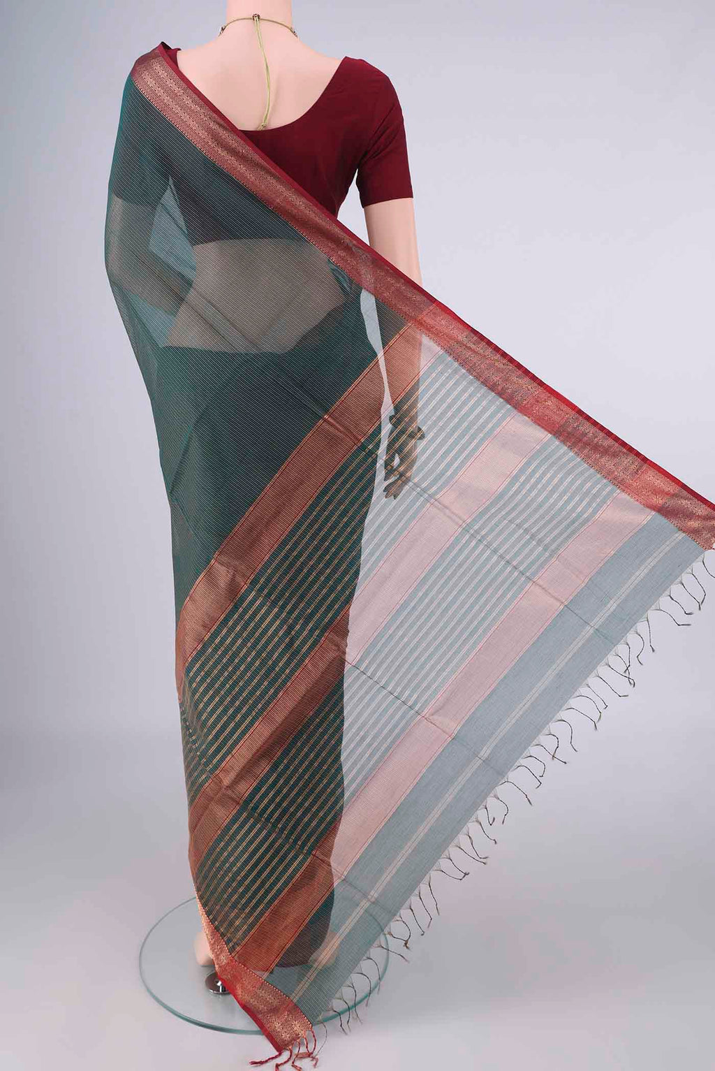 Flat view of Bottle Green Maheshwari Cotton Saree with Stripes on the body and Zari Border. 