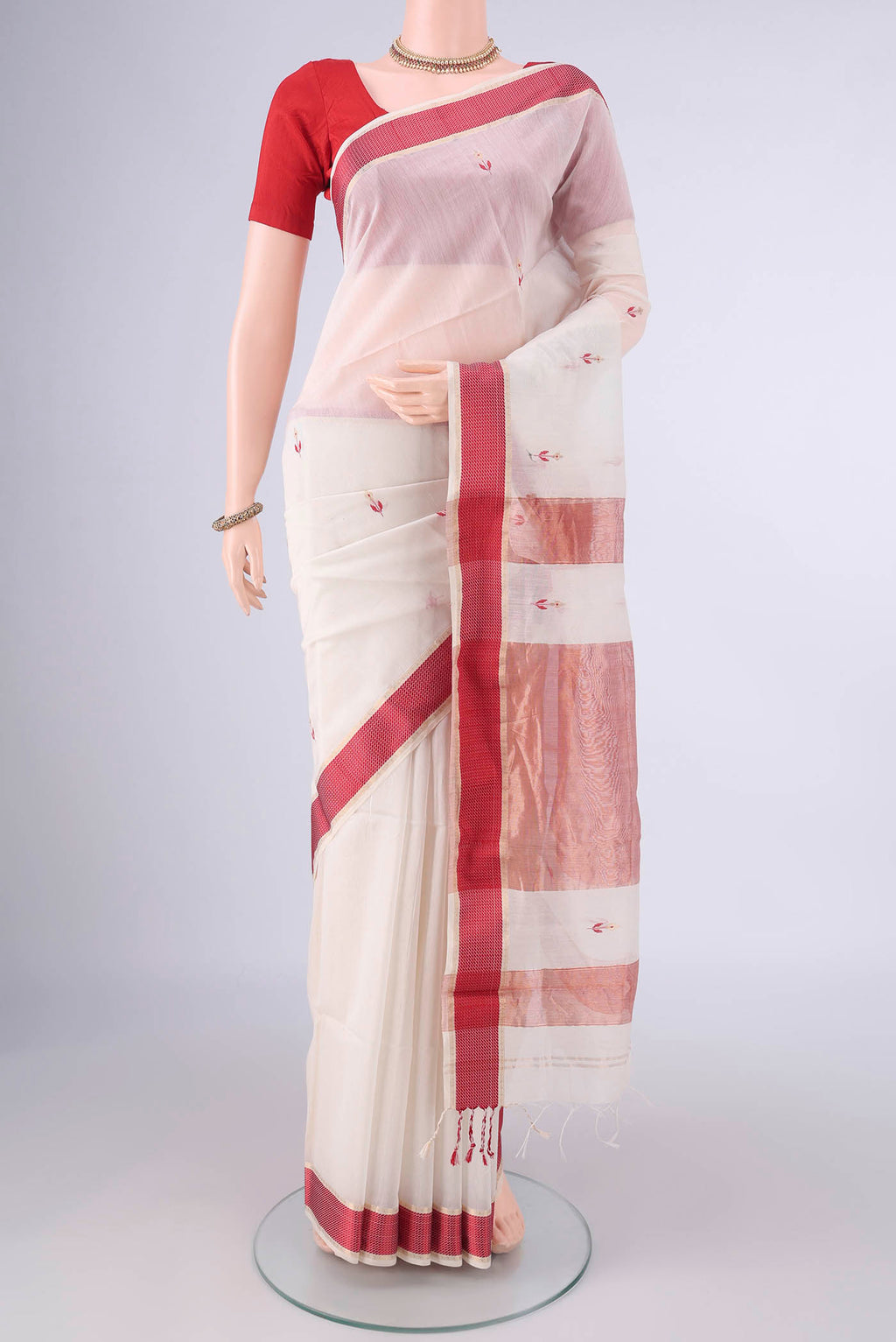 Off White Maheshwari Cotton Saree with Zari And Thread Butta on the body and Zari Border.  displayed on a mannequin
