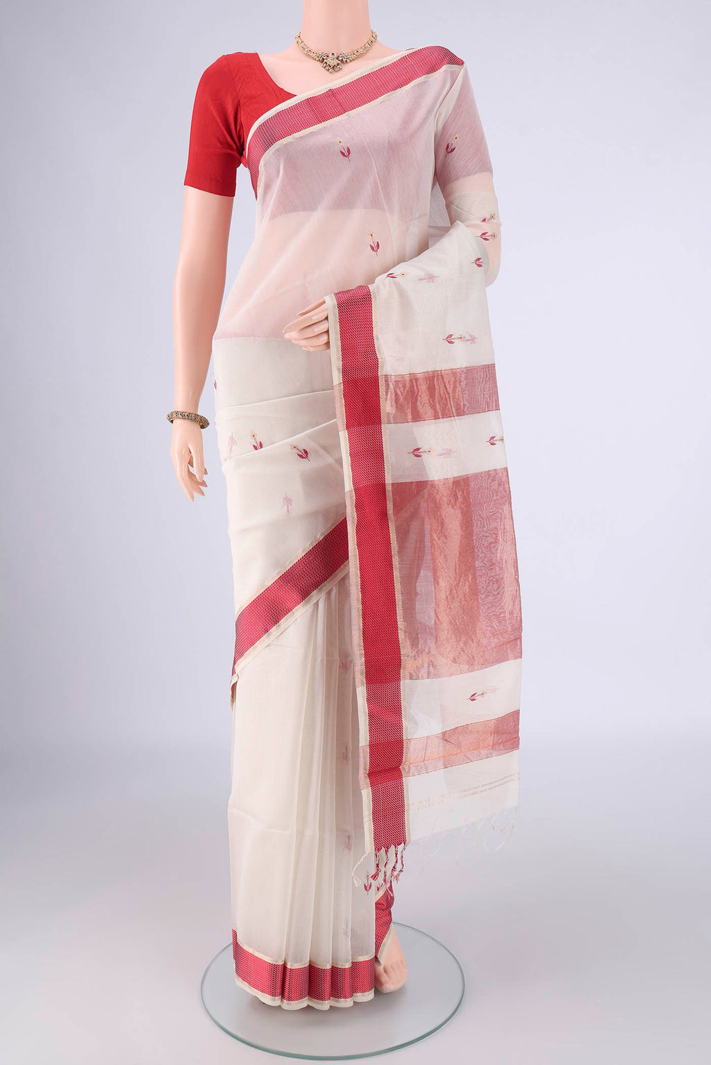 White Maheshwari Silk Cotton Saree with Zari And Thread Butta on the body and Thread Border.  displayed on a mannequin