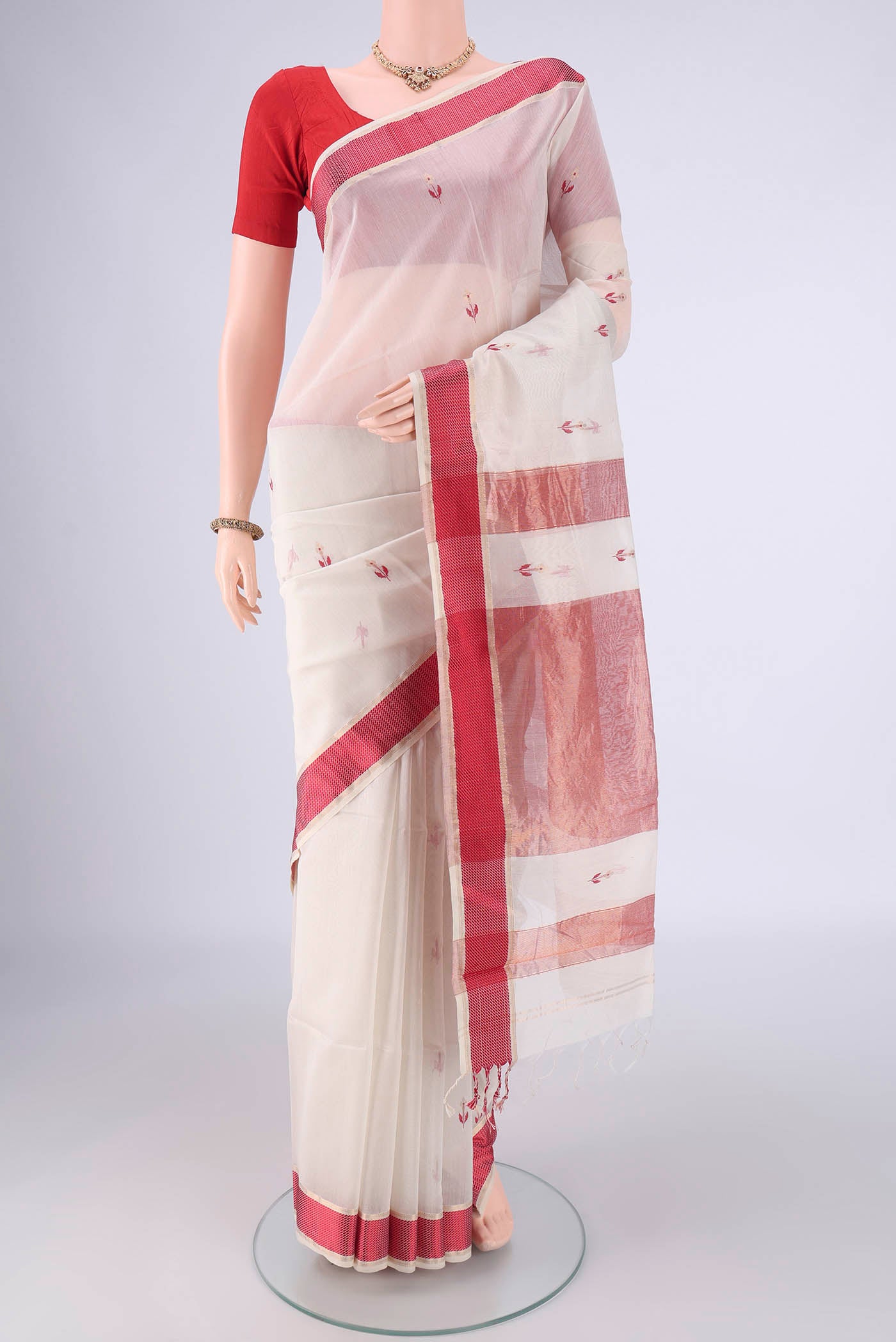 White Maheshwari Silk Cotton Saree with Zari And Thread Butta on the body and Thread Border.  displayed on a mannequin