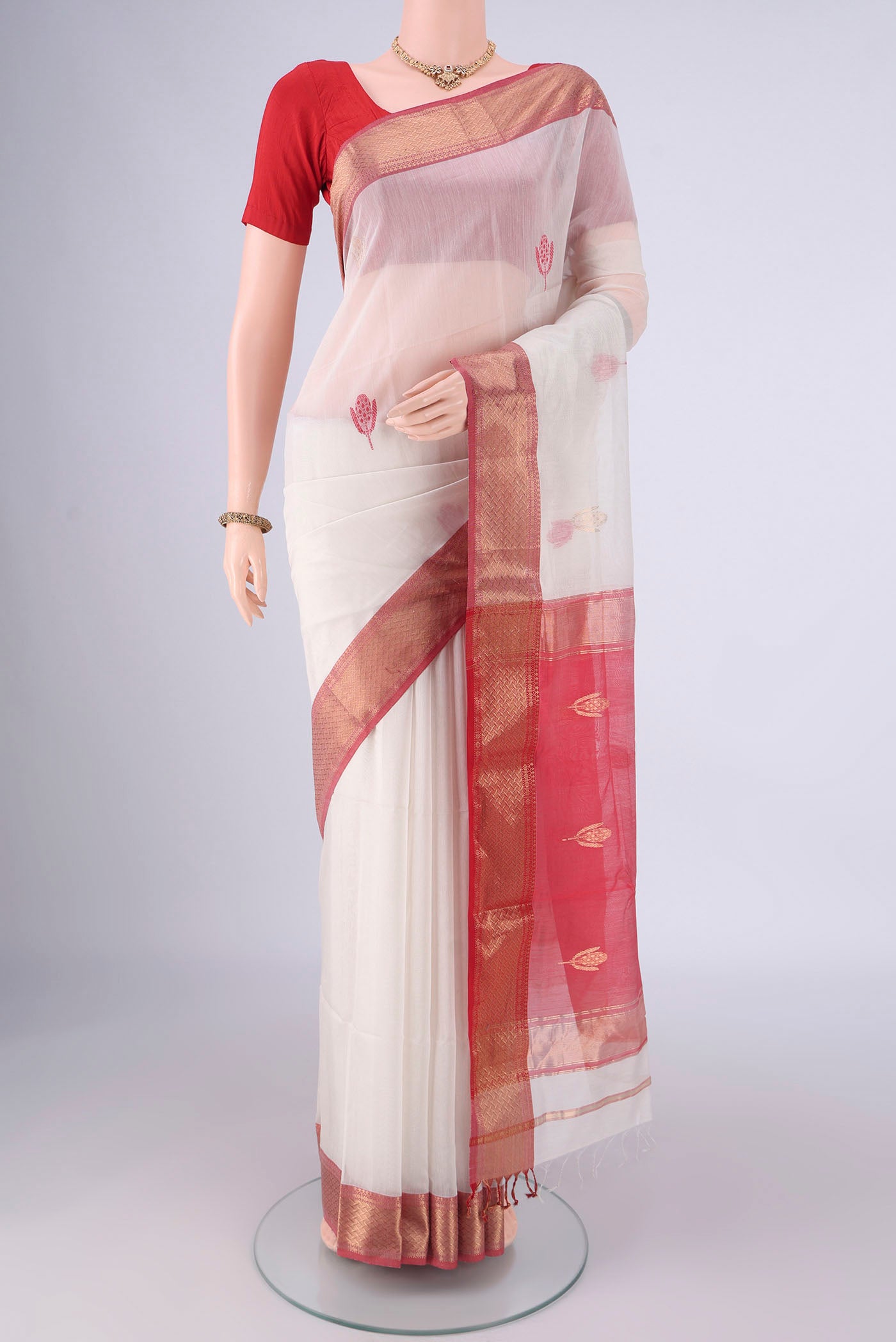 White Maheshwari Silk Cotton Saree with Thread Butta on the body and Zari Border.  displayed on a mannequin