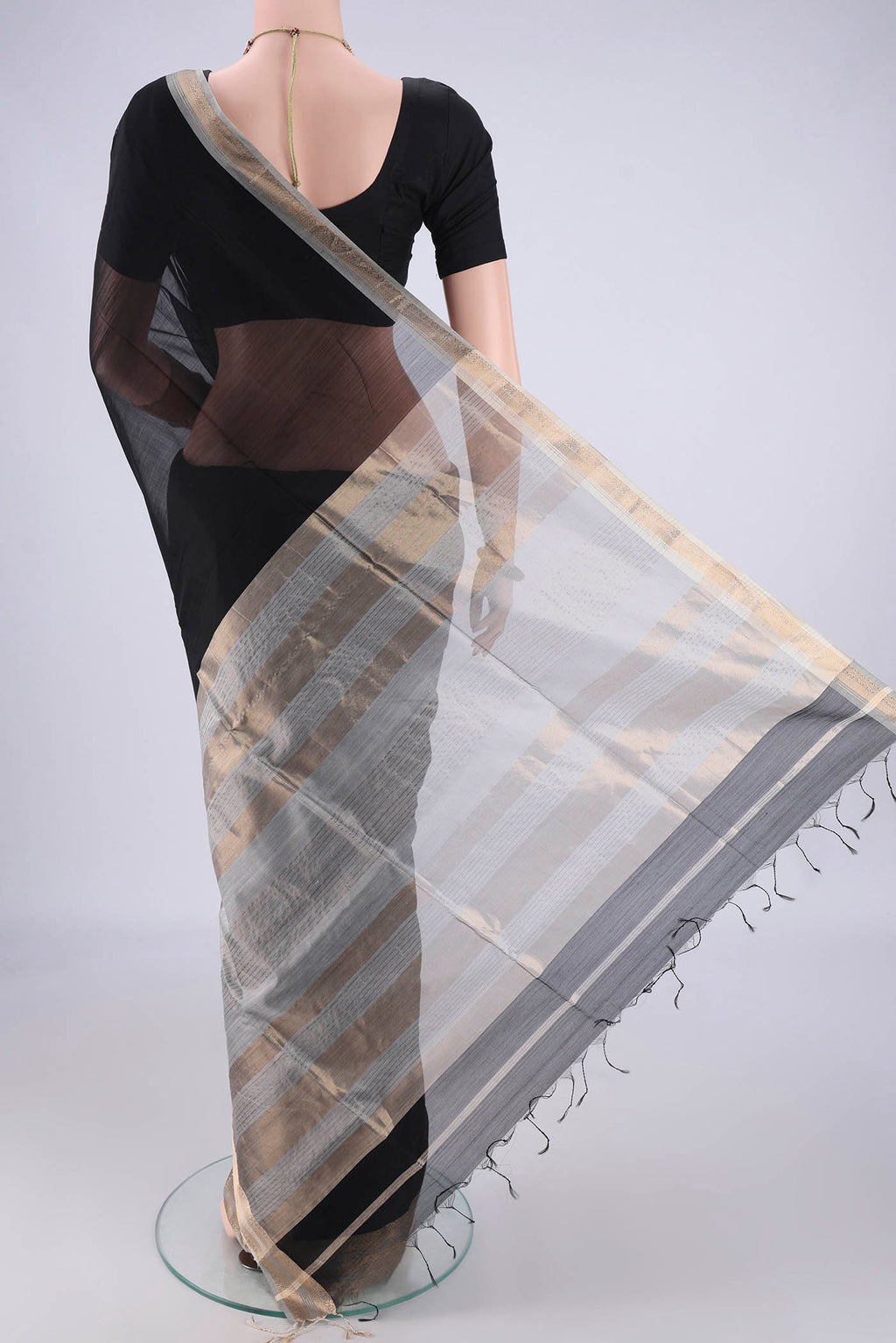 Flat view of Black Maheshwari Silk Cotton Saree with Plain Body and Zari Border. 