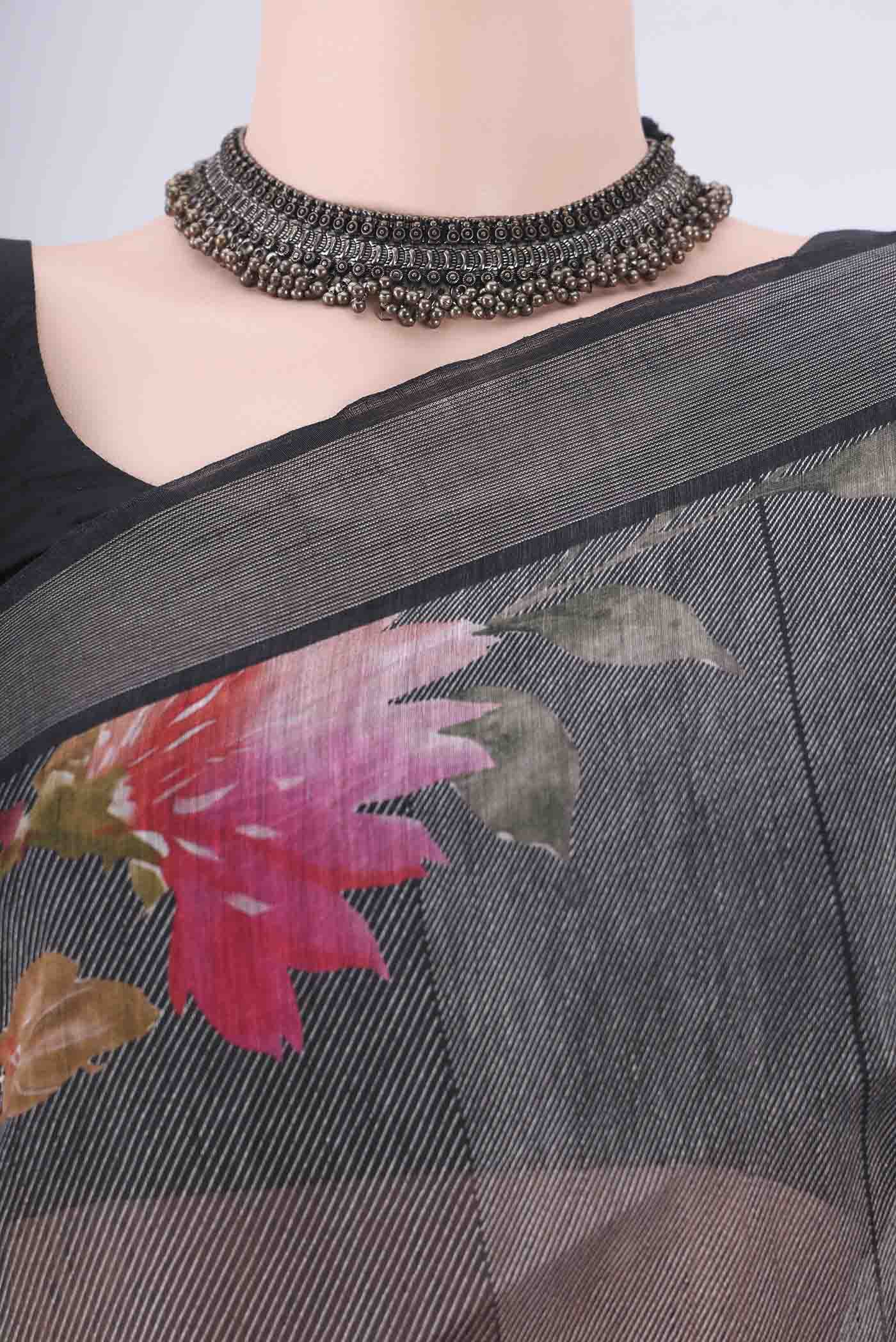 Border image of Black Linen Saree with Printed design on the body and Zari Border. 