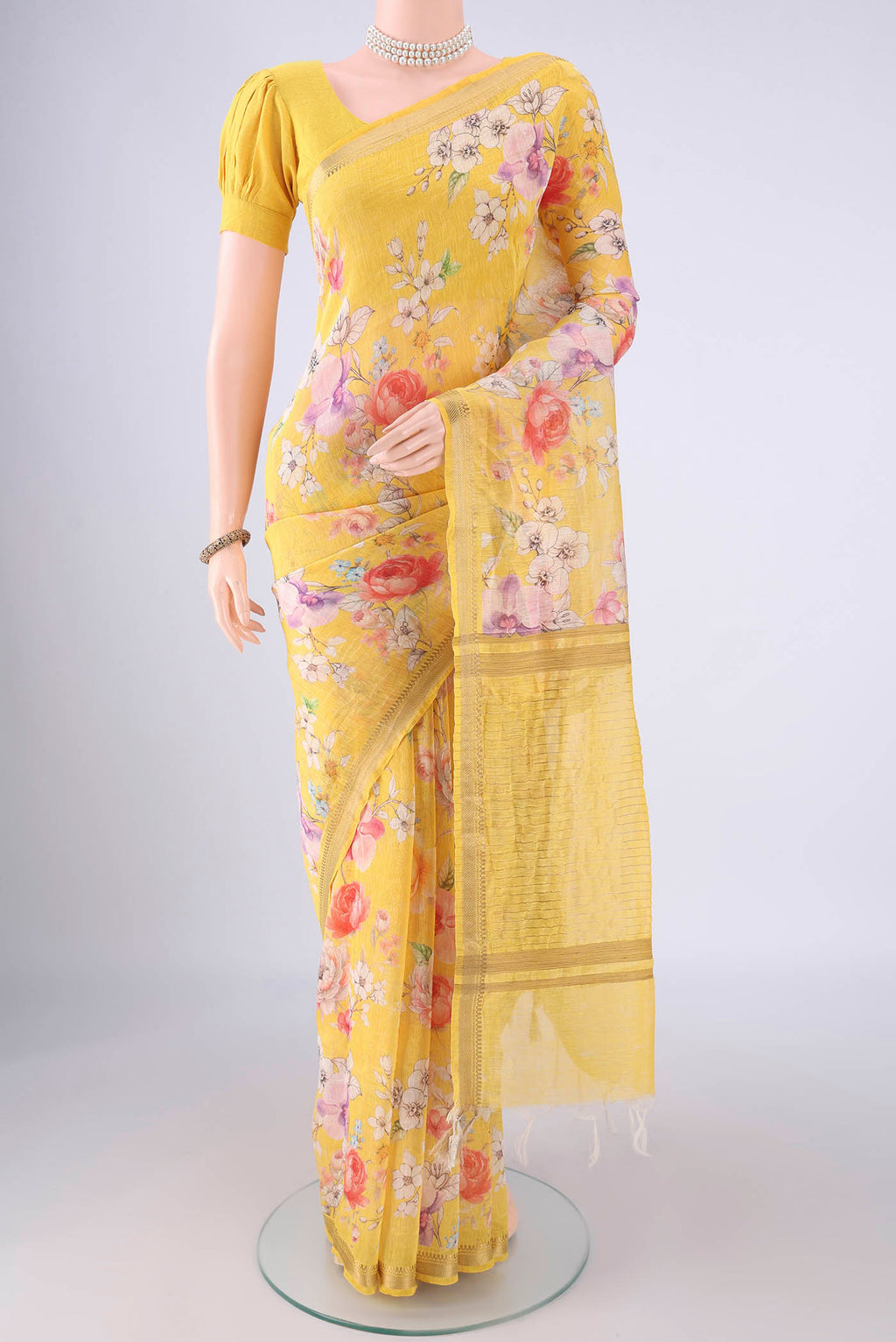 Lemon Yellow Linen Saree with Printed design on the body and Zari Border.  displayed on a mannequin