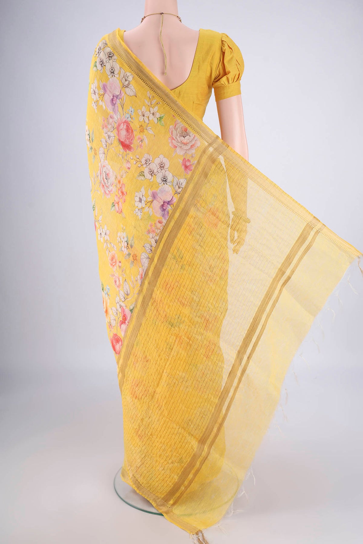 Flat view of Lemon Yellow Linen Saree with Printed design on the body and Zari Border. 