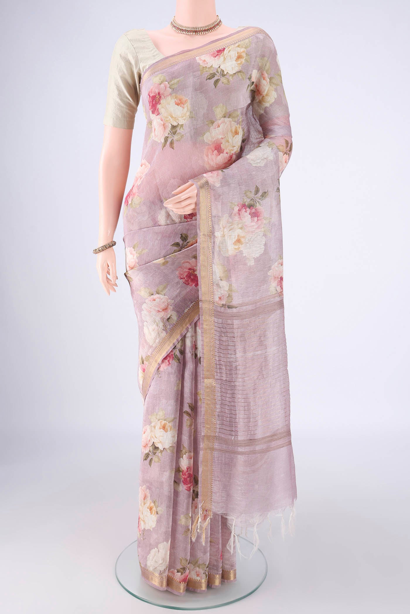 Mauve Linen Saree with Printed design on the body and Zari Border.  displayed on a mannequin