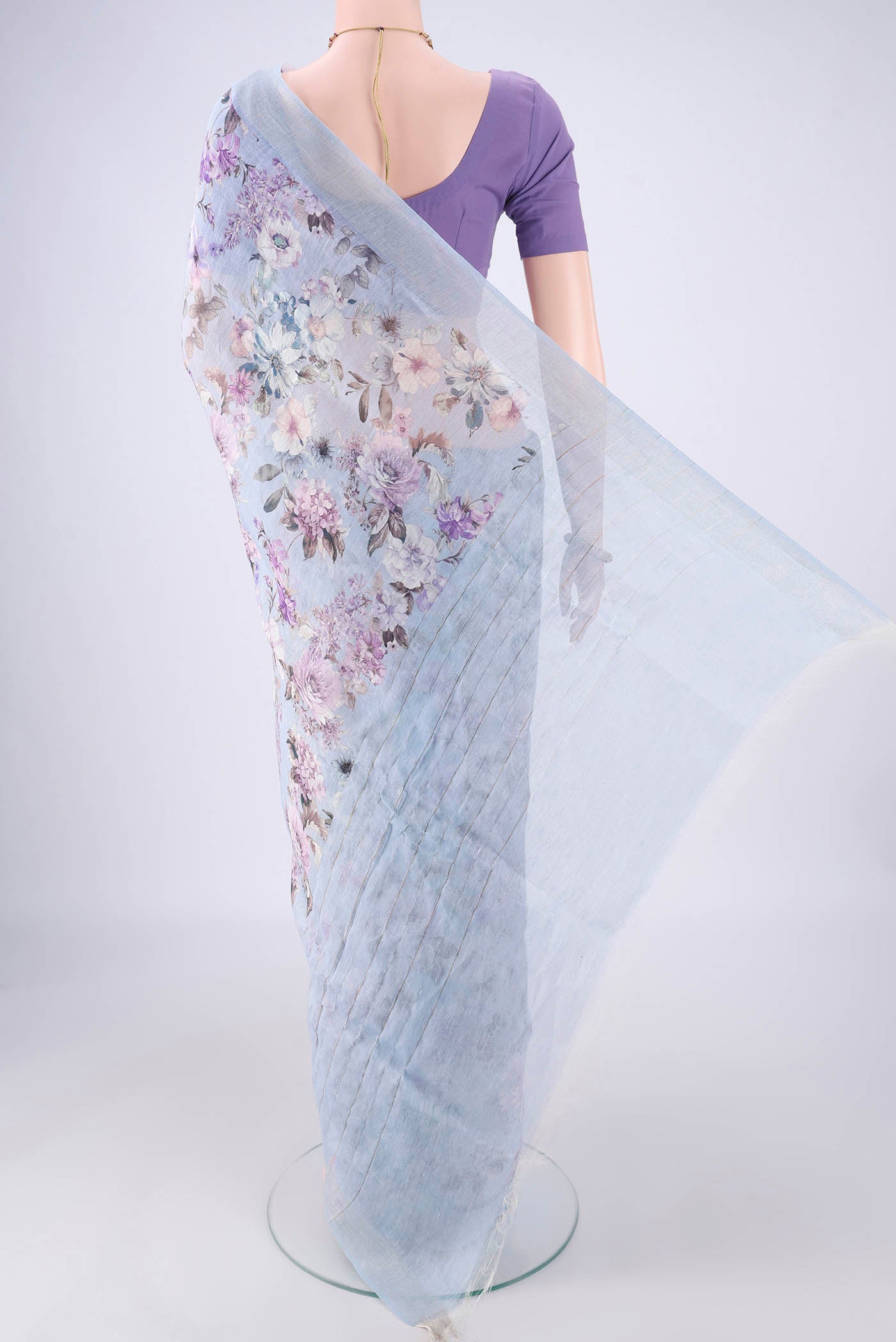 Flat view of Sky Blue Linen Saree with Printed design on the body and Zari Border. 