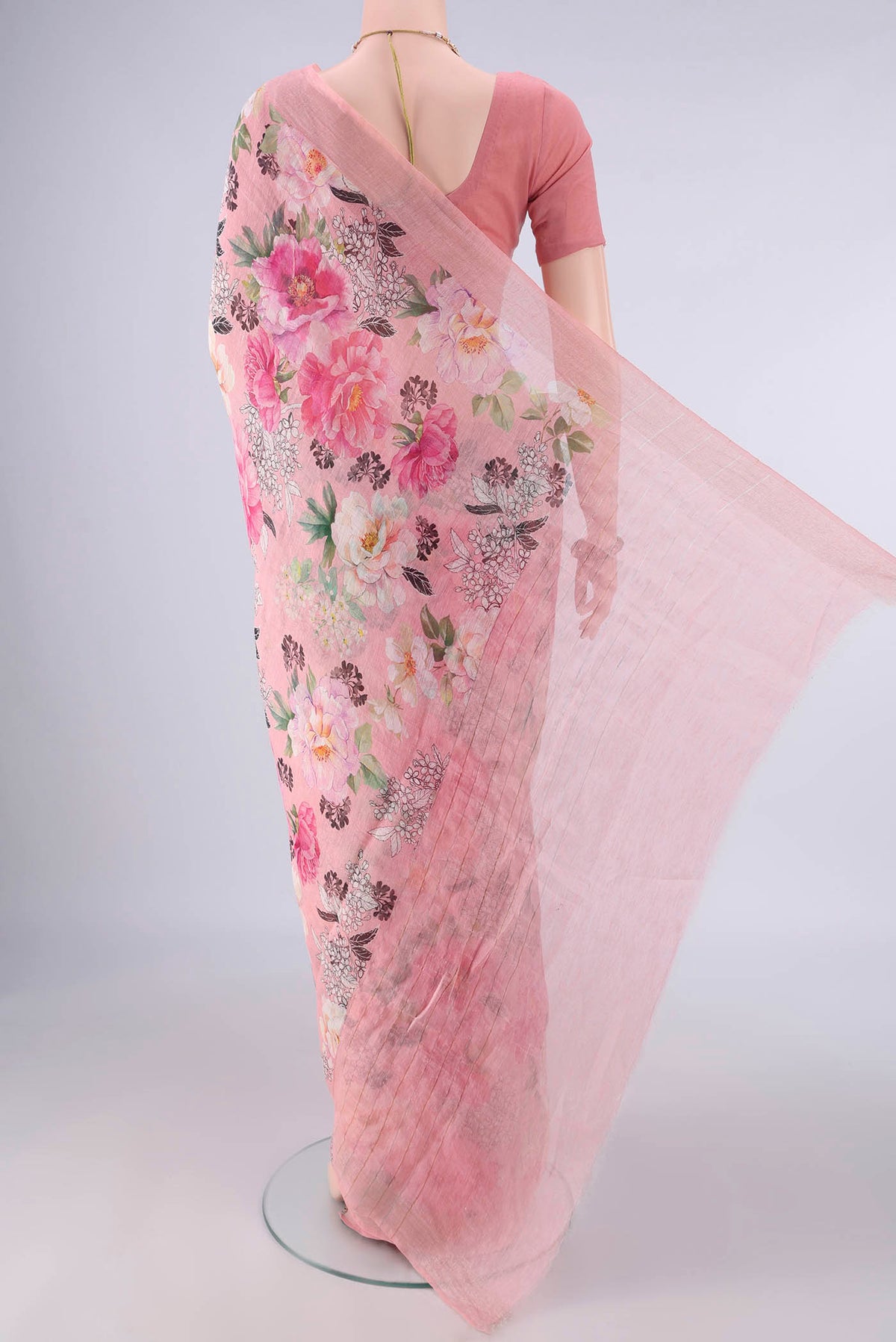Flat view of Peach Linen Saree with Floral Print on the body and Zari Border. 