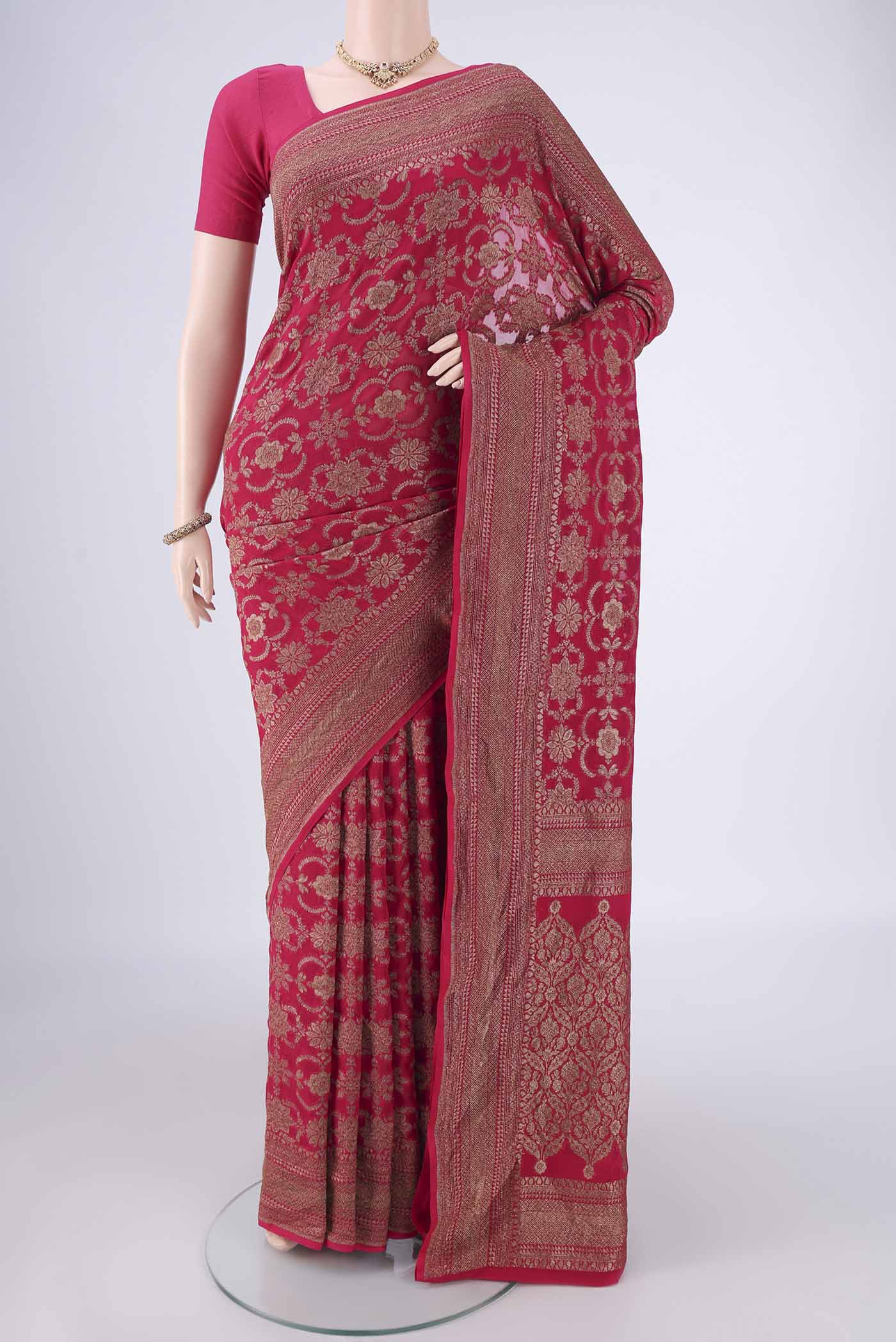 Rani Pink Banarasi Georgette Saree with Zari Brocade on the body and Zari Border.  displayed on a mannequin