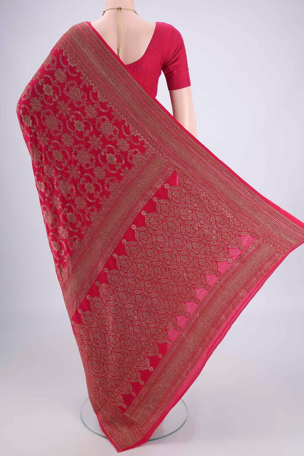 Flat view of Rani Pink Banarasi Georgette Saree with Zari Brocade on the body and Zari Border. 