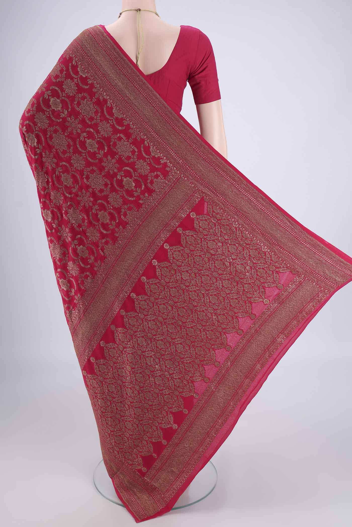 Flat view of Rani Pink Banarasi Georgette Saree with Zari Brocade on the body and Zari Border. 