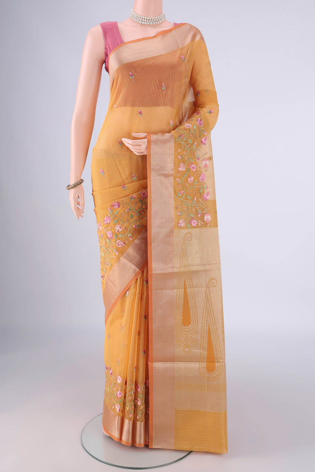 Mustard Kota Cotton Saree with Embroidery on the body and Zari Border.  displayed on a mannequin
