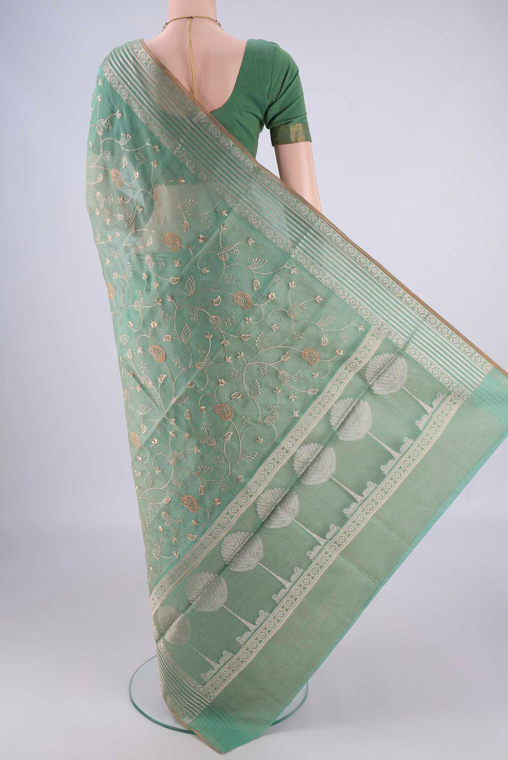 Flat view of Light Green Blended Kota Cotton Saree with Embroidery on the body and Zari Border. 