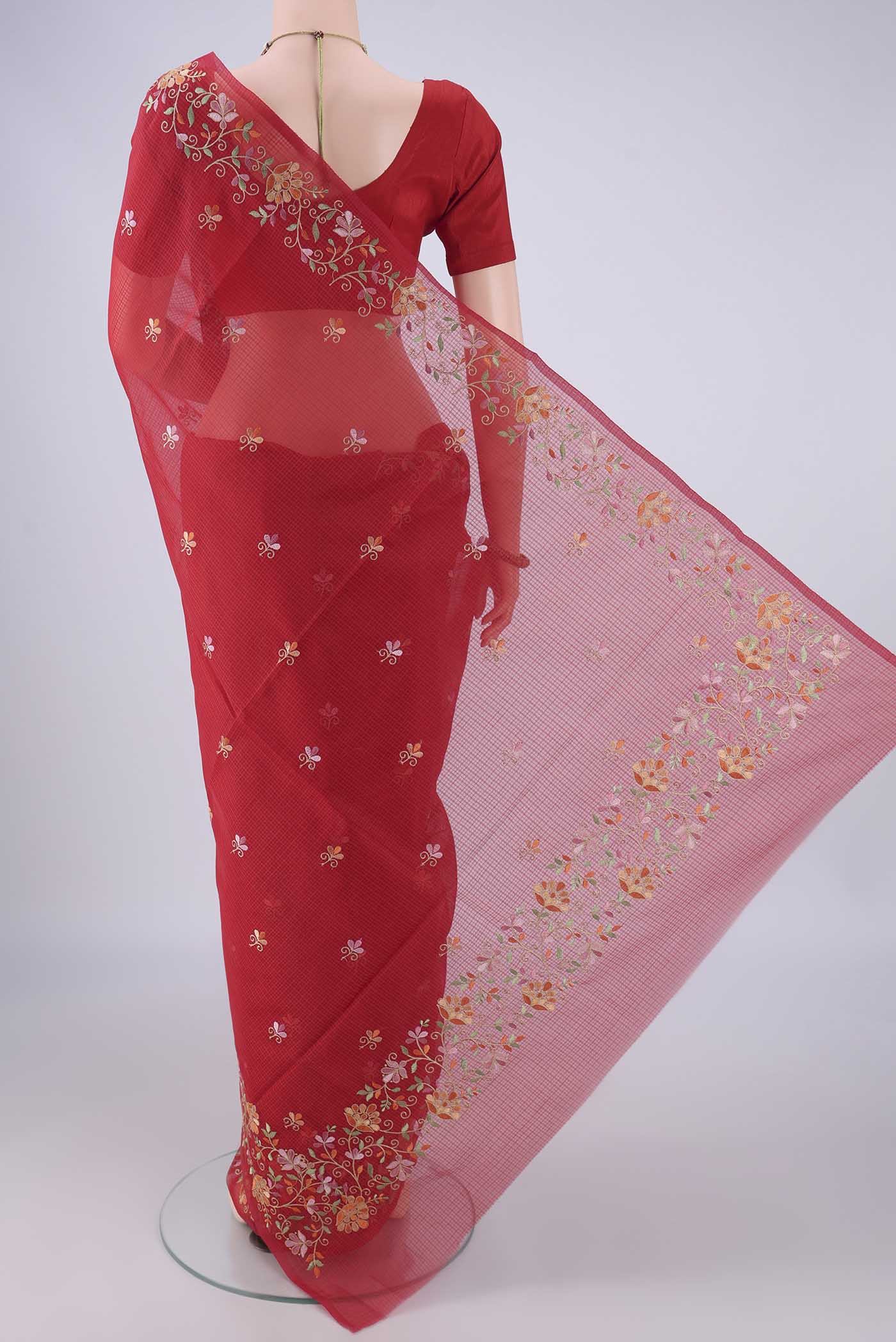 Flat view of Red Blended Kota Cotton Saree with Embroidery on the body and Embroidery Border. 