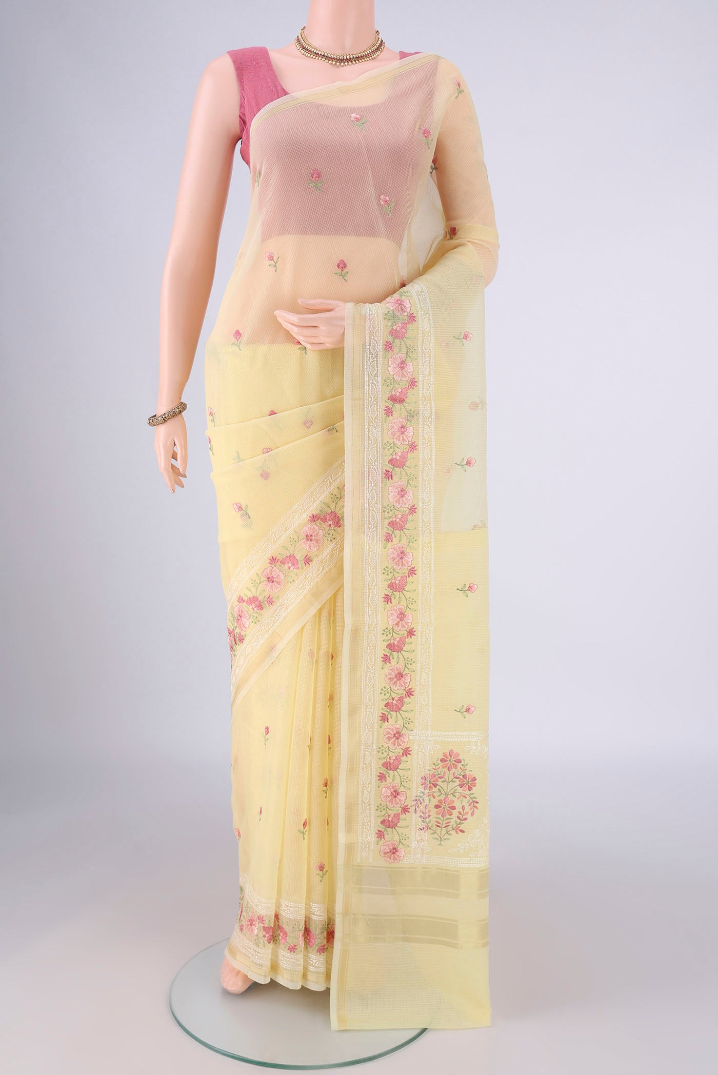 Lemon Yellow Blended Kota Cotton Saree with Embroidery on the body and Zari Border.  displayed on a mannequin