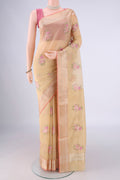 Beige Blended Kota Cotton Saree with Embroidery on the body and Zari Border.  displayed on a mannequin