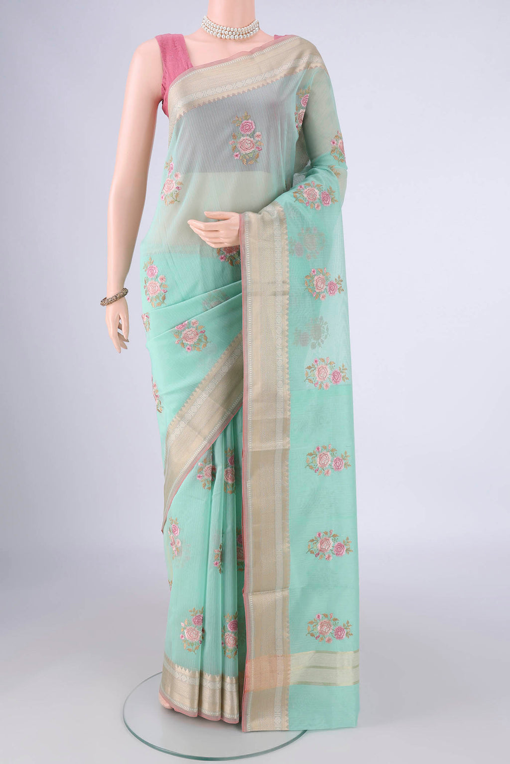 Turquoise Blended Kota Cotton Saree with Embroidery on the body and Zari Border.  displayed on a mannequin