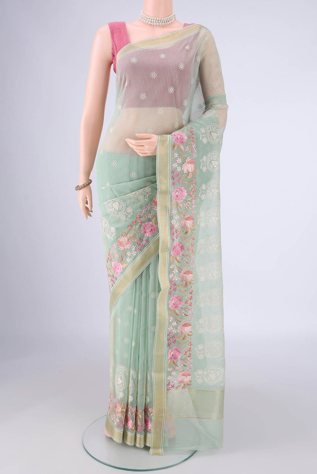 Mint Green Blended Kota Cotton Saree with Embroidery on the body and Zari Border.  displayed on a mannequin