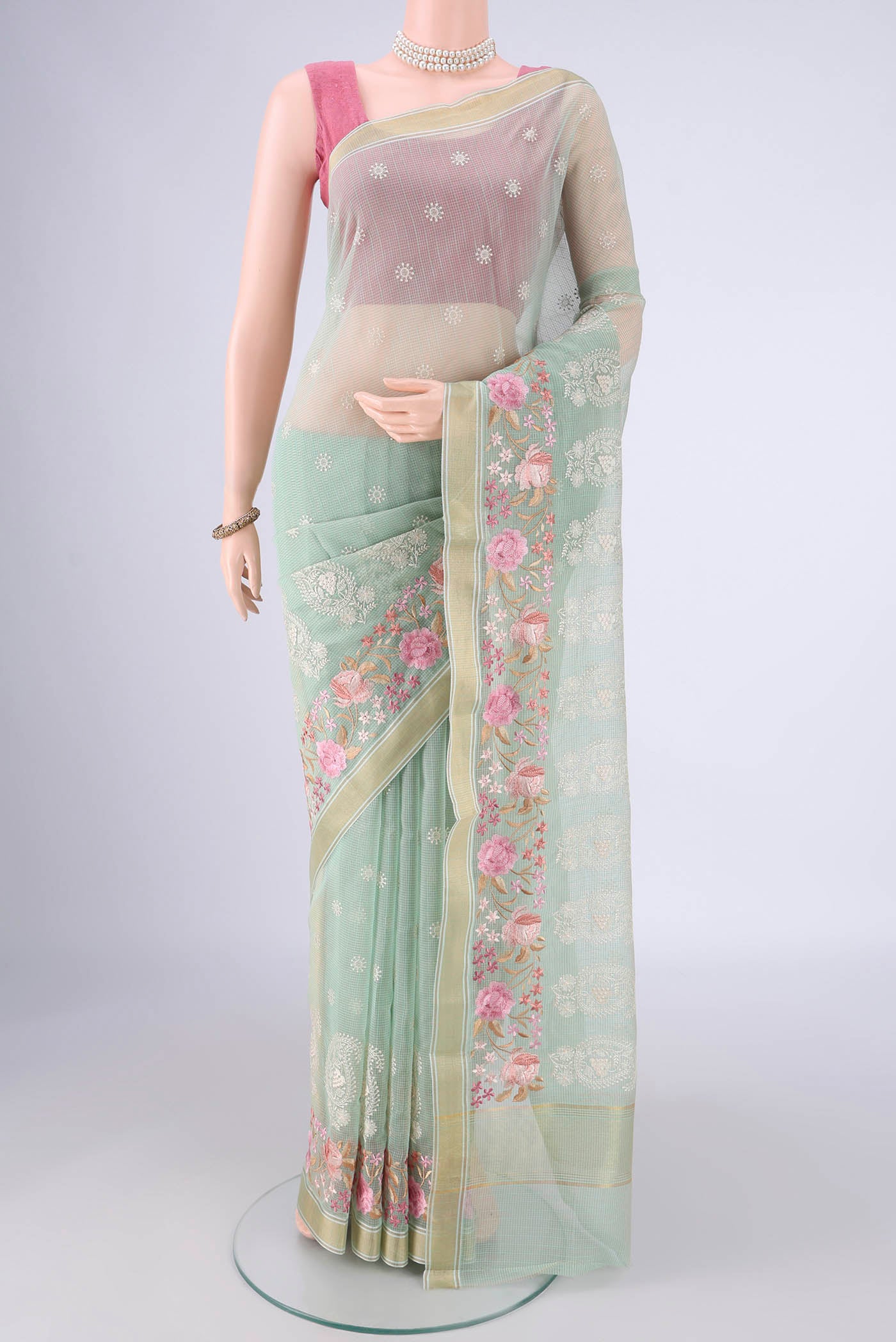 Mint Green Blended Kota Cotton Saree with Embroidery on the body and Zari Border.  displayed on a mannequin